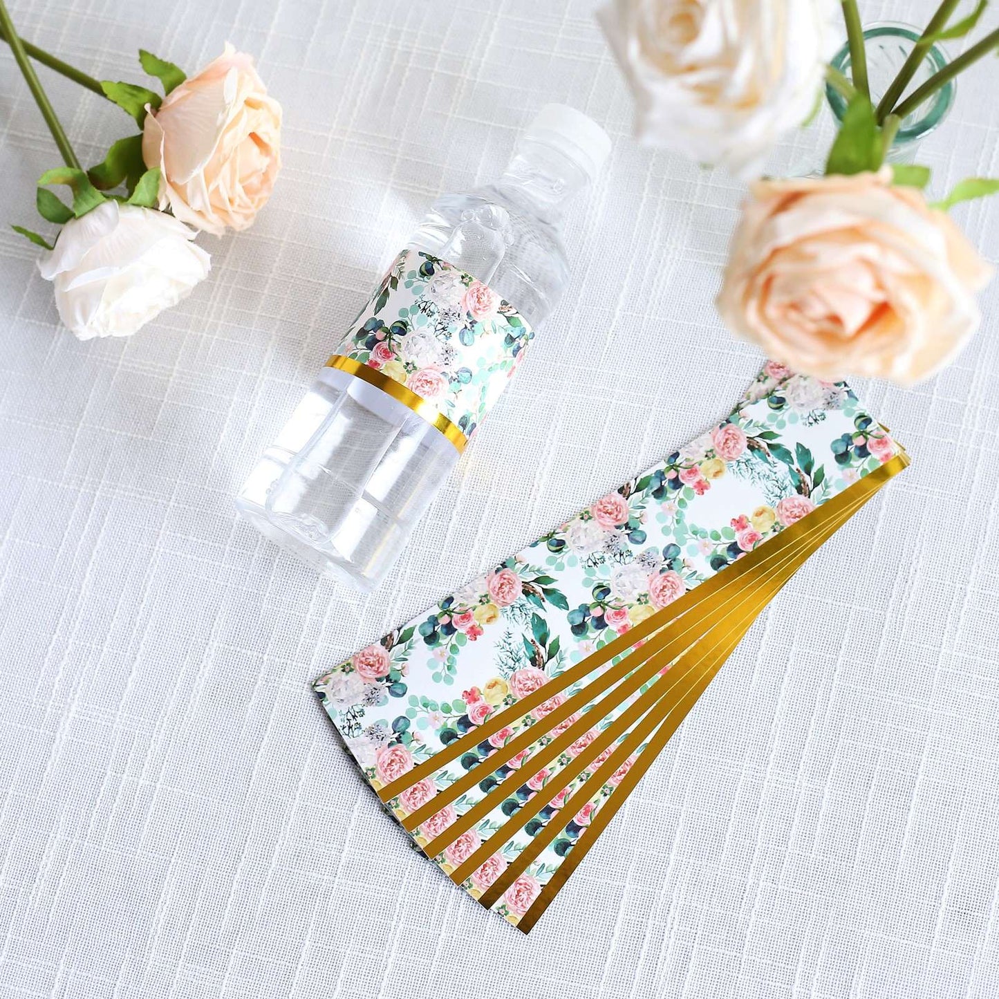 White and pink water bottle labels with floral design and gold trim.