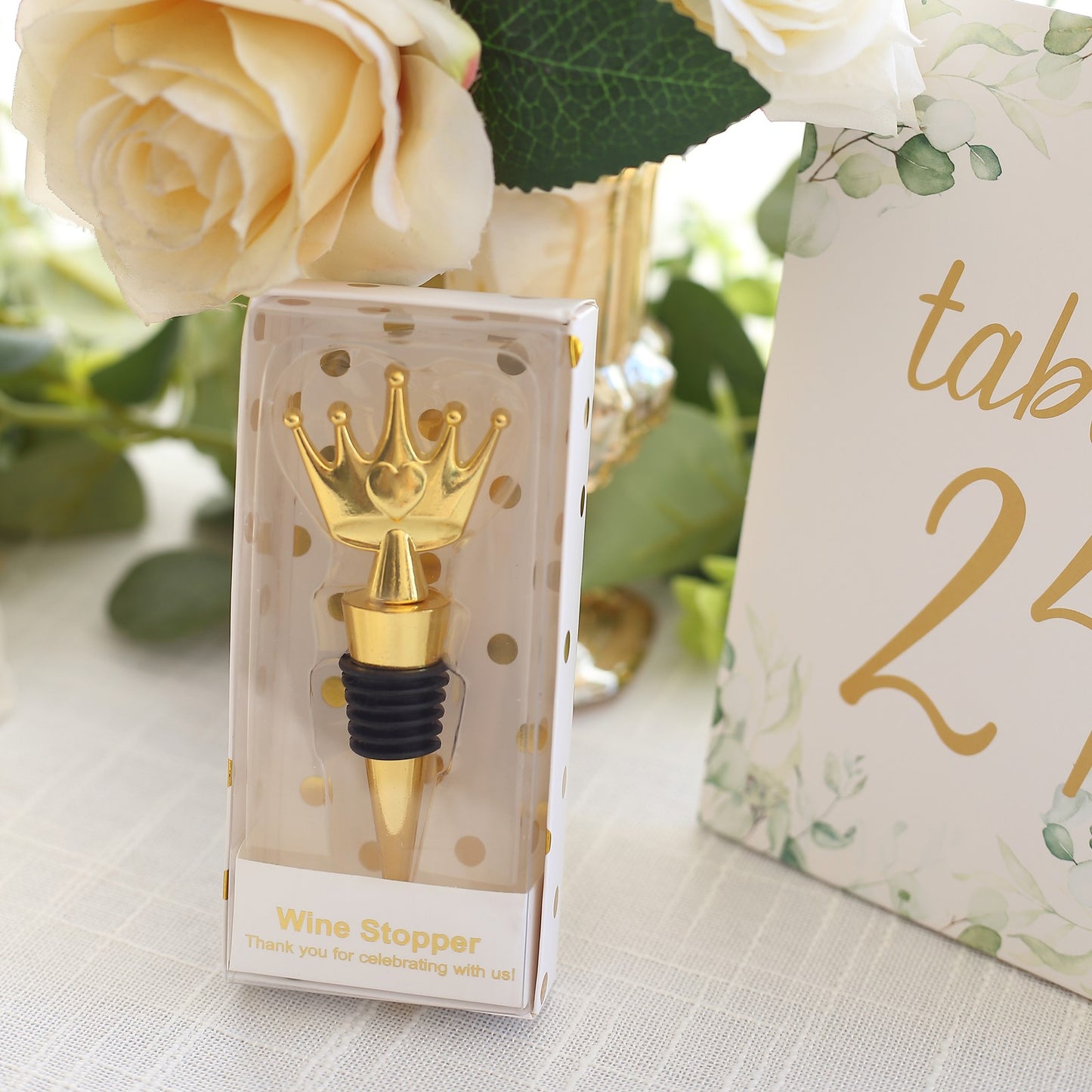 Gold metal princess crown wine bottle stopper in clear gift box with tag and ribbon.