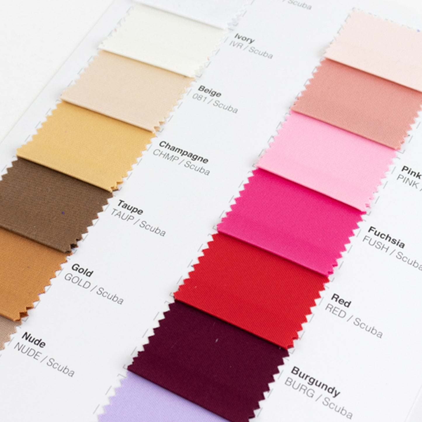 Scuba fabric sample book swatches in various colors including taupe and fuchsia.