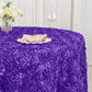 Purple satin round tablecloth with 3D rosettes for elegant table settings.