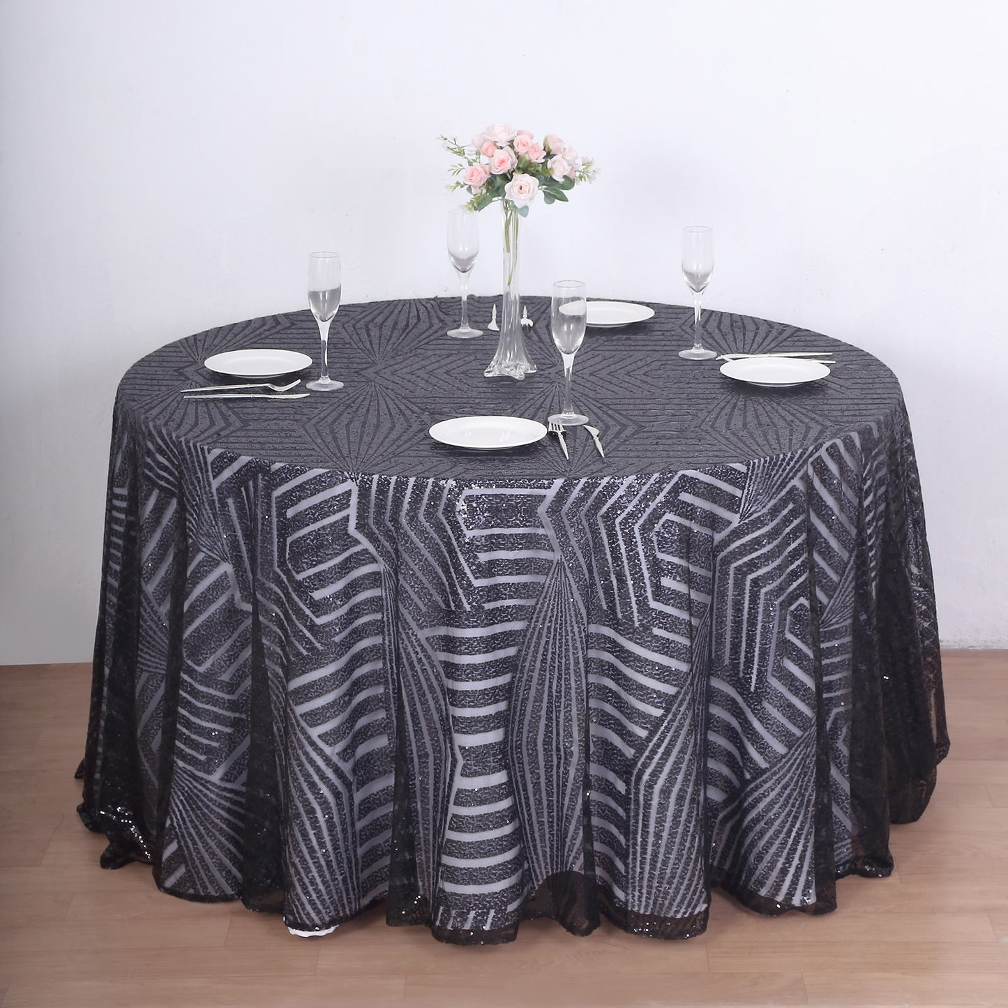120" black seamless diamond glitz sequin round tablecloth on a dining table.