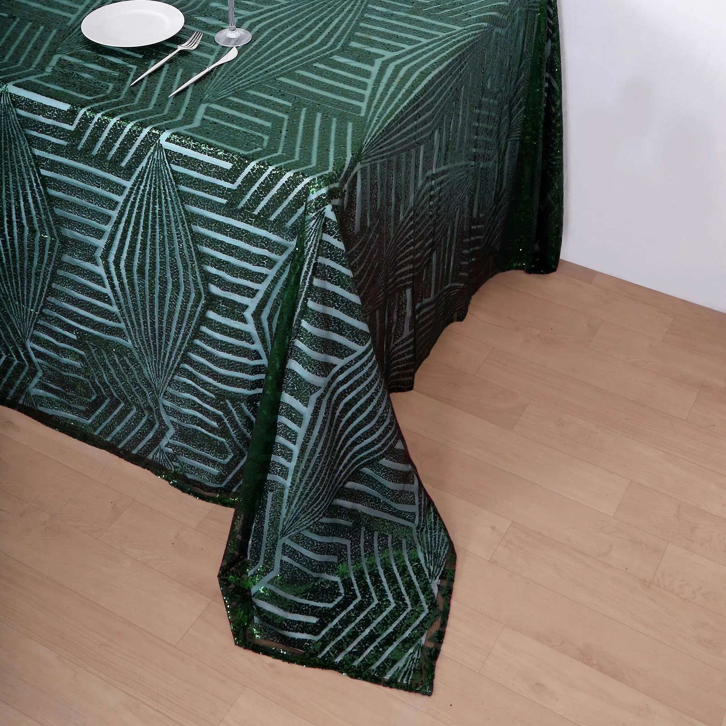 Hunter Emerald Green Sequin Tablecloth on a wooden table.