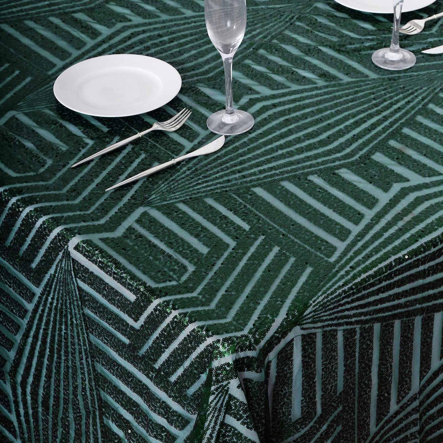 Emerald green sequin rectangular tablecloth on a dining table.