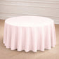 Blush round seamless polyester tablecloth on a wooden floor.
