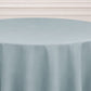 Dusty blue seamless round tablecloth on a table.