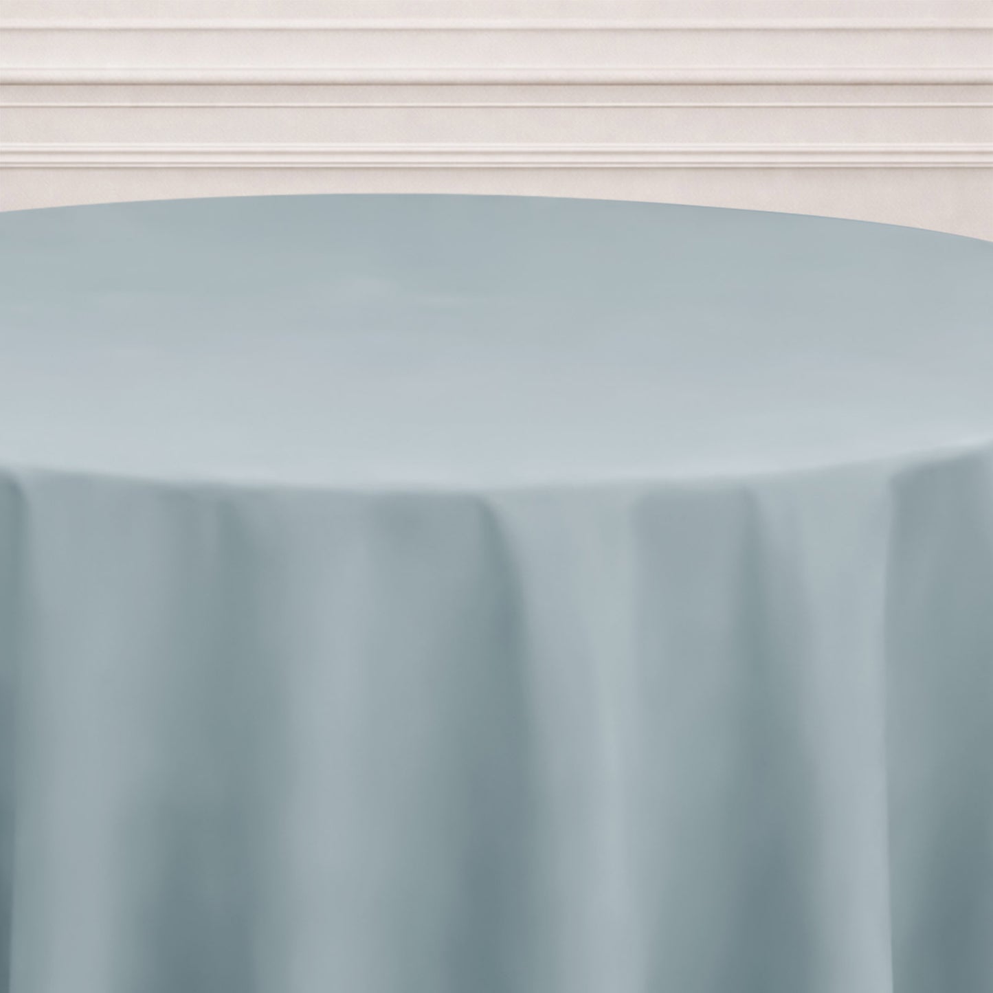 Dusty blue seamless round tablecloth on a table.
