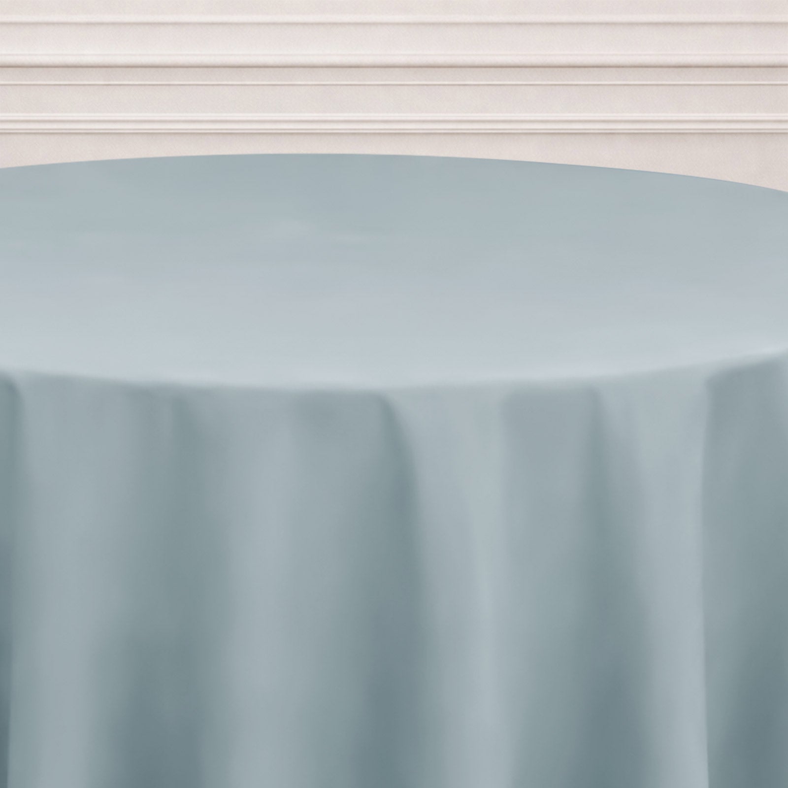 Dusty blue seamless round tablecloth on a table.