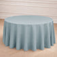 Dusty blue seamless round tablecloth on a wooden floor.