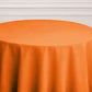 Orange round tablecloth for events and dining.