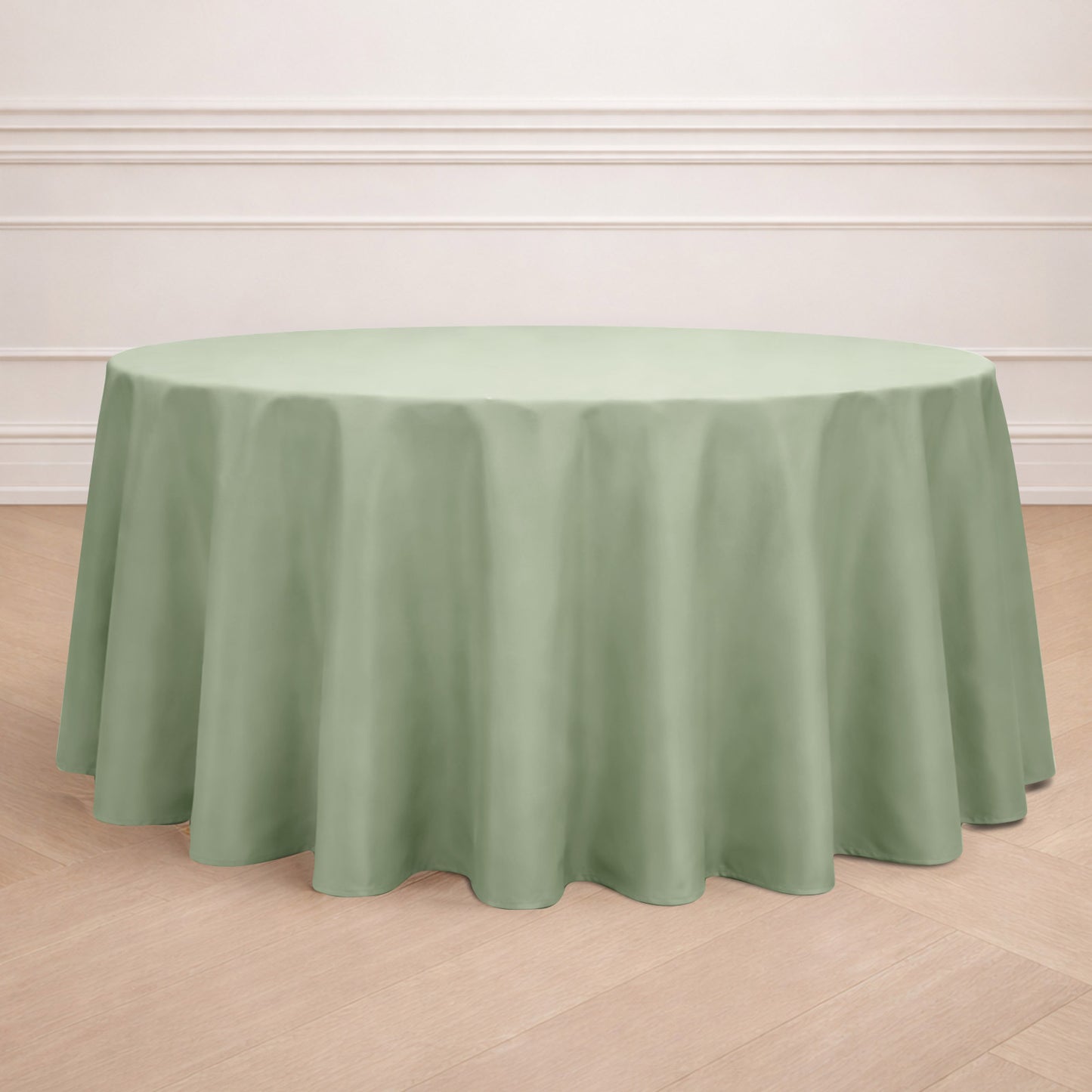 Sage green seamless round tablecloth on a wooden floor.