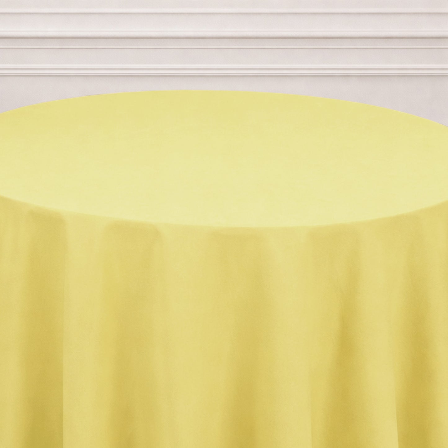 Yellow round tablecloth on a table, perfect for events and gatherings.