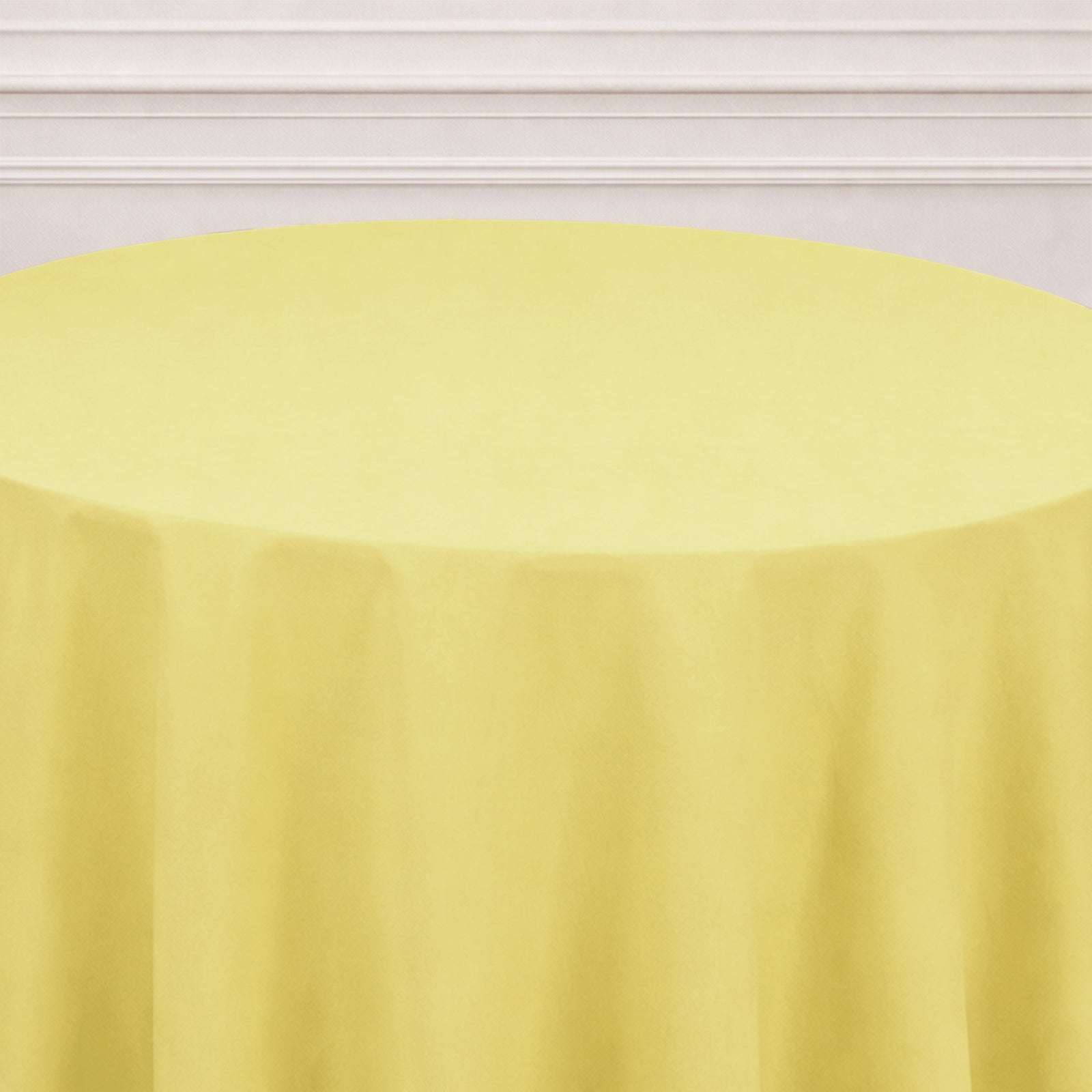 Yellow round tablecloth on a table, perfect for events and gatherings.