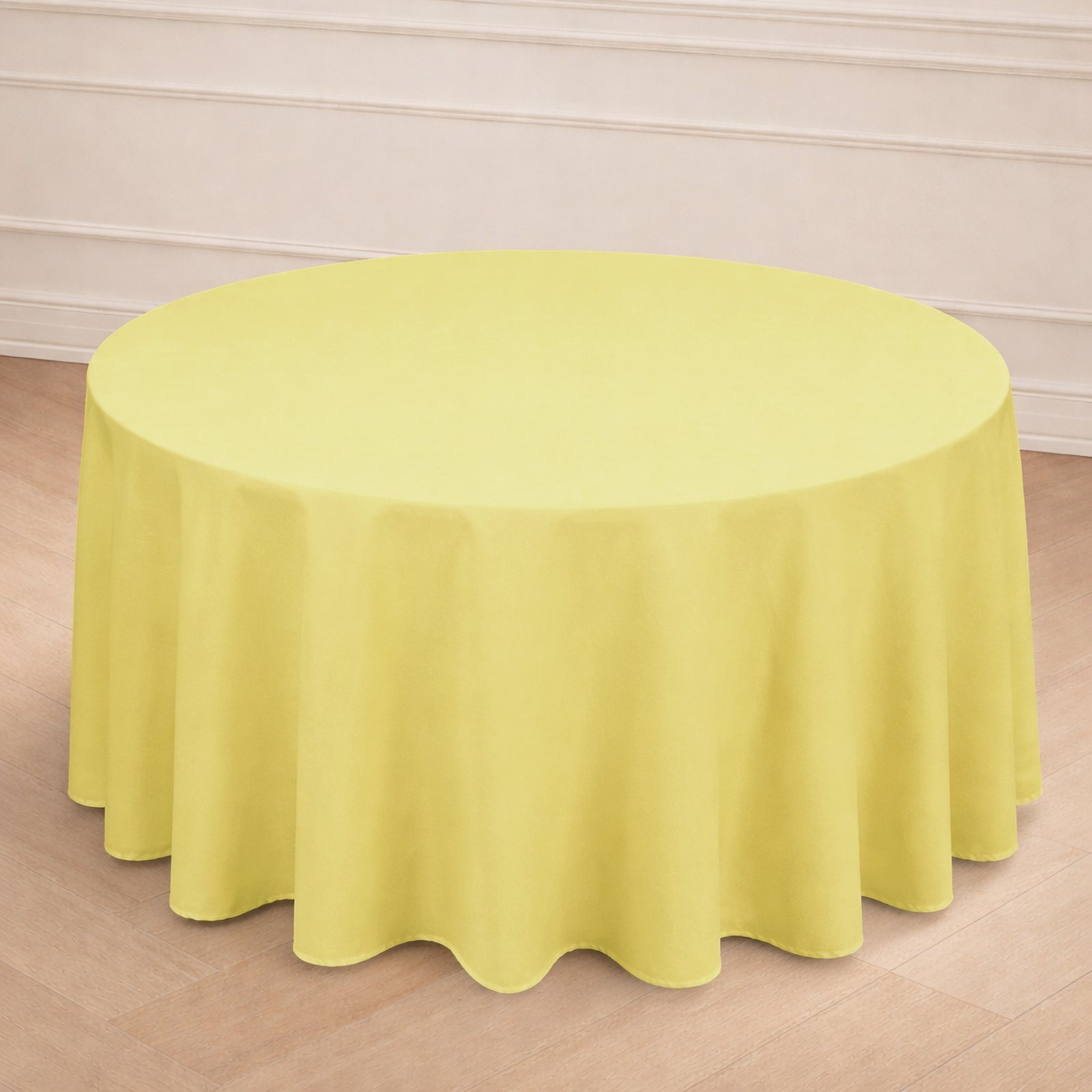 Yellow round tablecloth draping a circular table in a light setting.