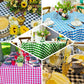 White and navy blue buffalo plaid square overlay tablecloth.