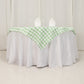 54"x54" white sage green buffalo plaid table overlay on a round table.