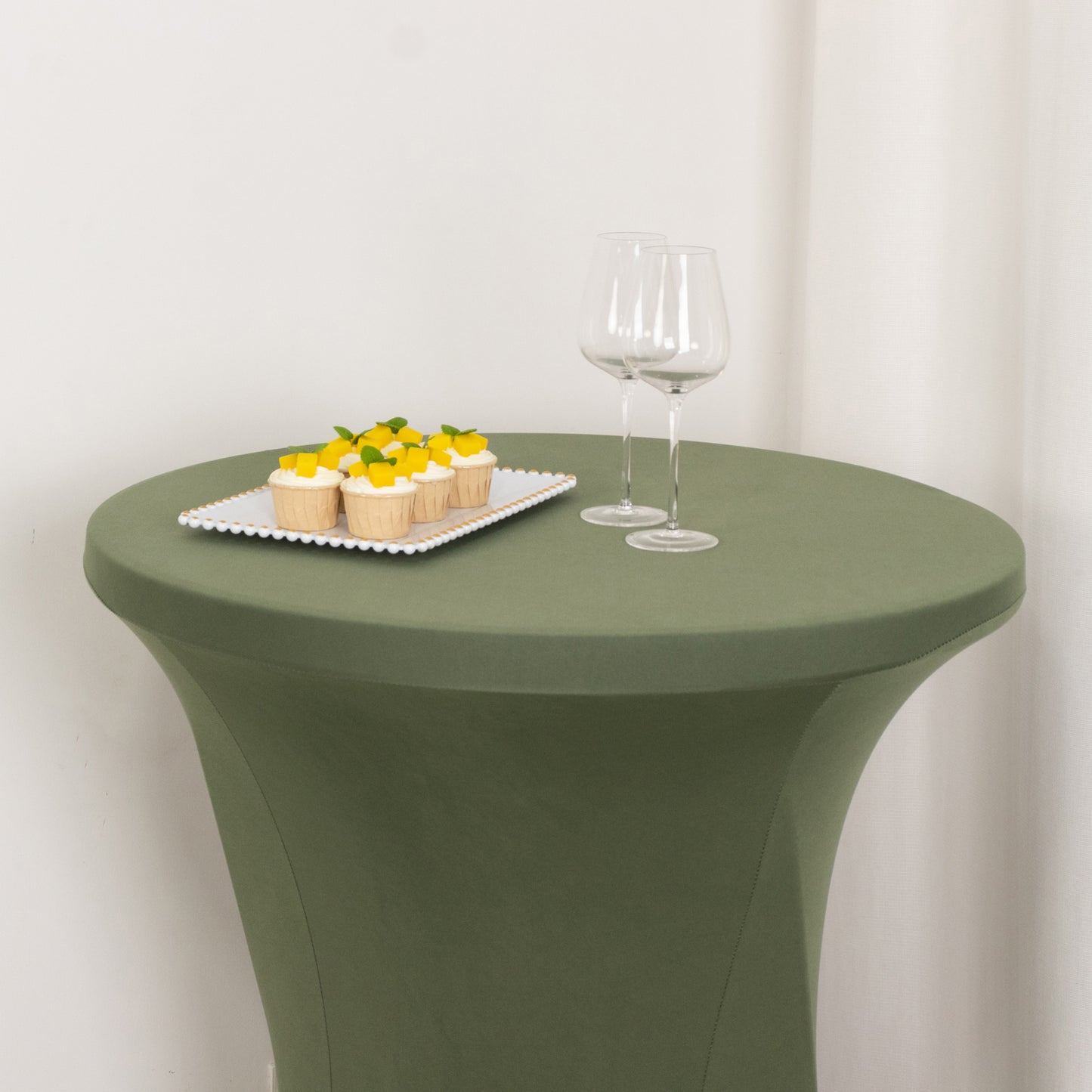 Dusty sage green fitted table cover for high top cocktail tables.