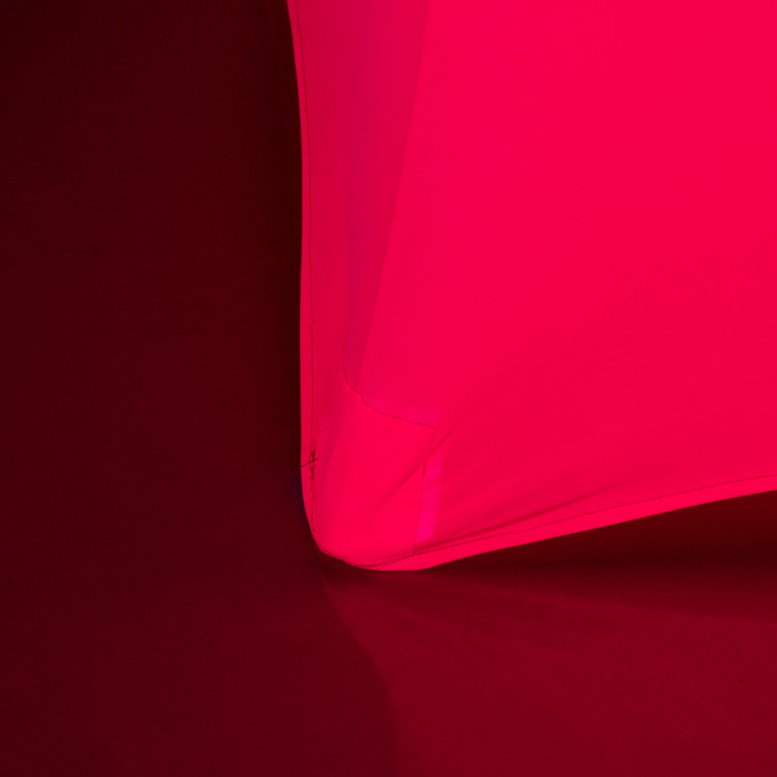 Glow Neon Fuchsia Fitted Spandex Cocktail Tablecloth on a round table.