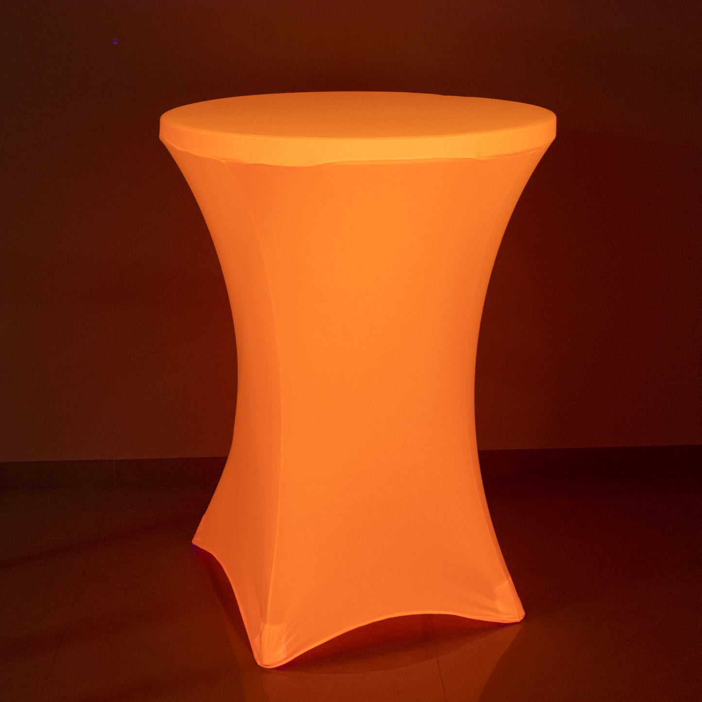 Glow Neon Orange Fitted Spandex Cocktail Tablecloth on a round table.