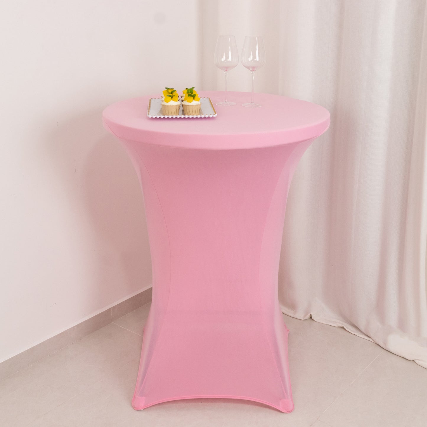 Pink fitted stretch tablecloth for 30" diameter high top tables.