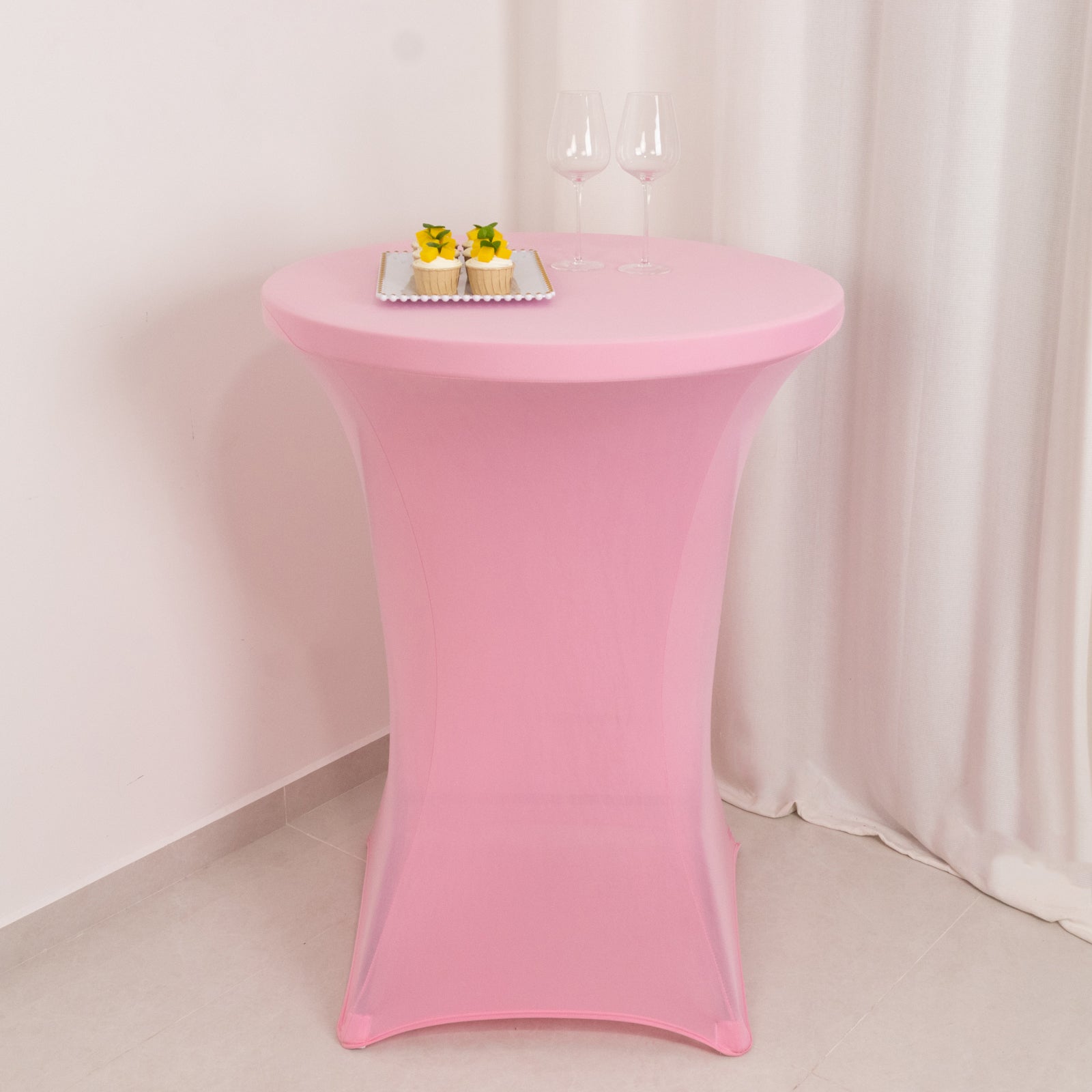 Pink fitted stretch tablecloth for 30" diameter high top tables.