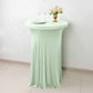 Sage green round cocktail table cover with natural wavy drapes.
