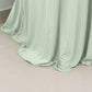 Sage green round cocktail table cover with natural wavy drapes.