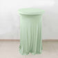 Sage green round cocktail table cover with natural wavy drapes.