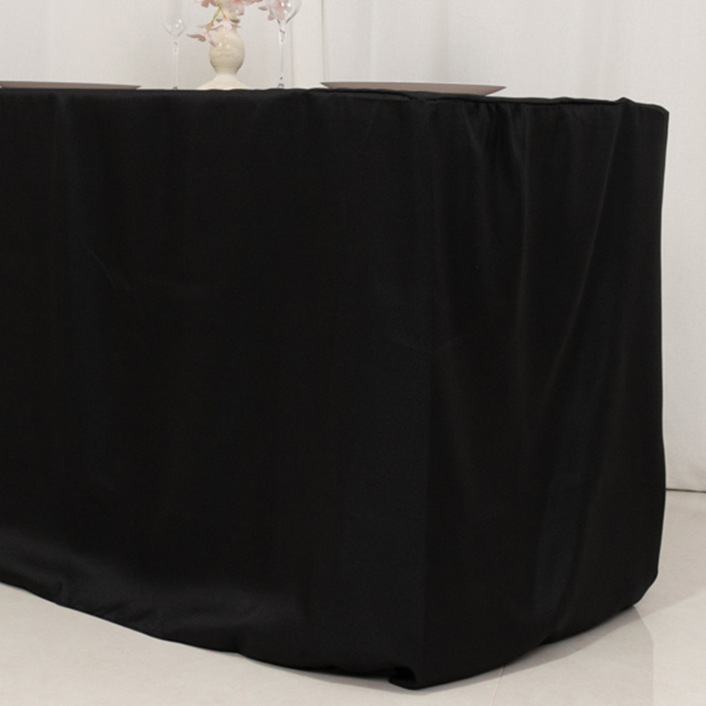 Black fitted polyester tablecloth for 48"x24"x30" tables.