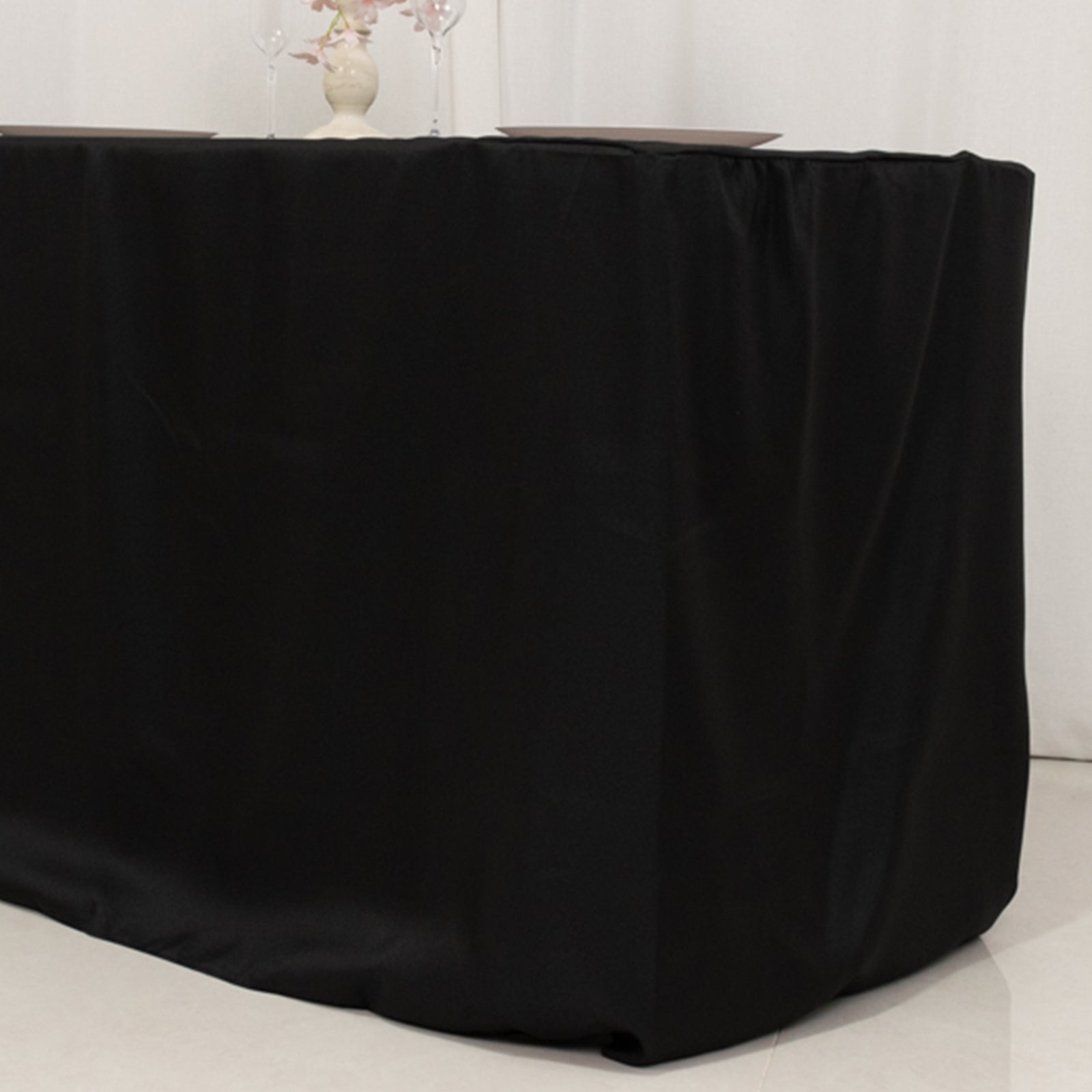 Black fitted polyester tablecloth for 48"x24"x30" tables.
