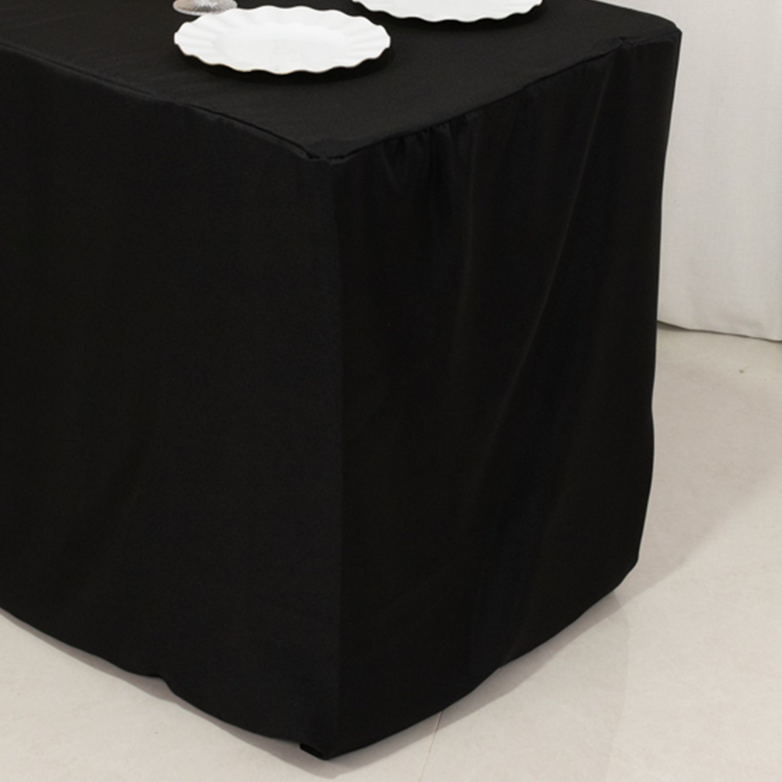 Black fitted polyester tablecloth for 48"x24"x30" tables.