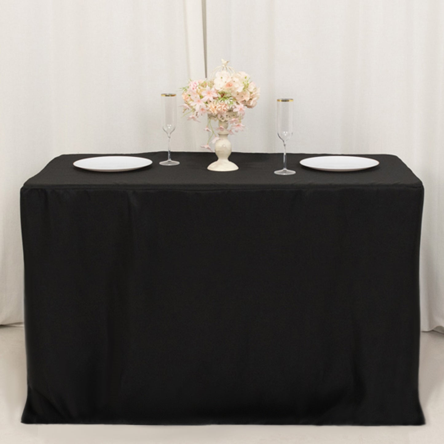 Black fitted tablecloth for 48"x24"x42" tables, elegantly styled with decor.
