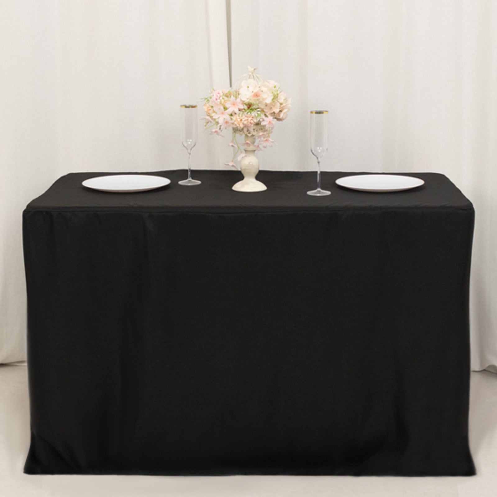 Black fitted tablecloth for 48"x24"x42" tables, elegantly styled with decor.