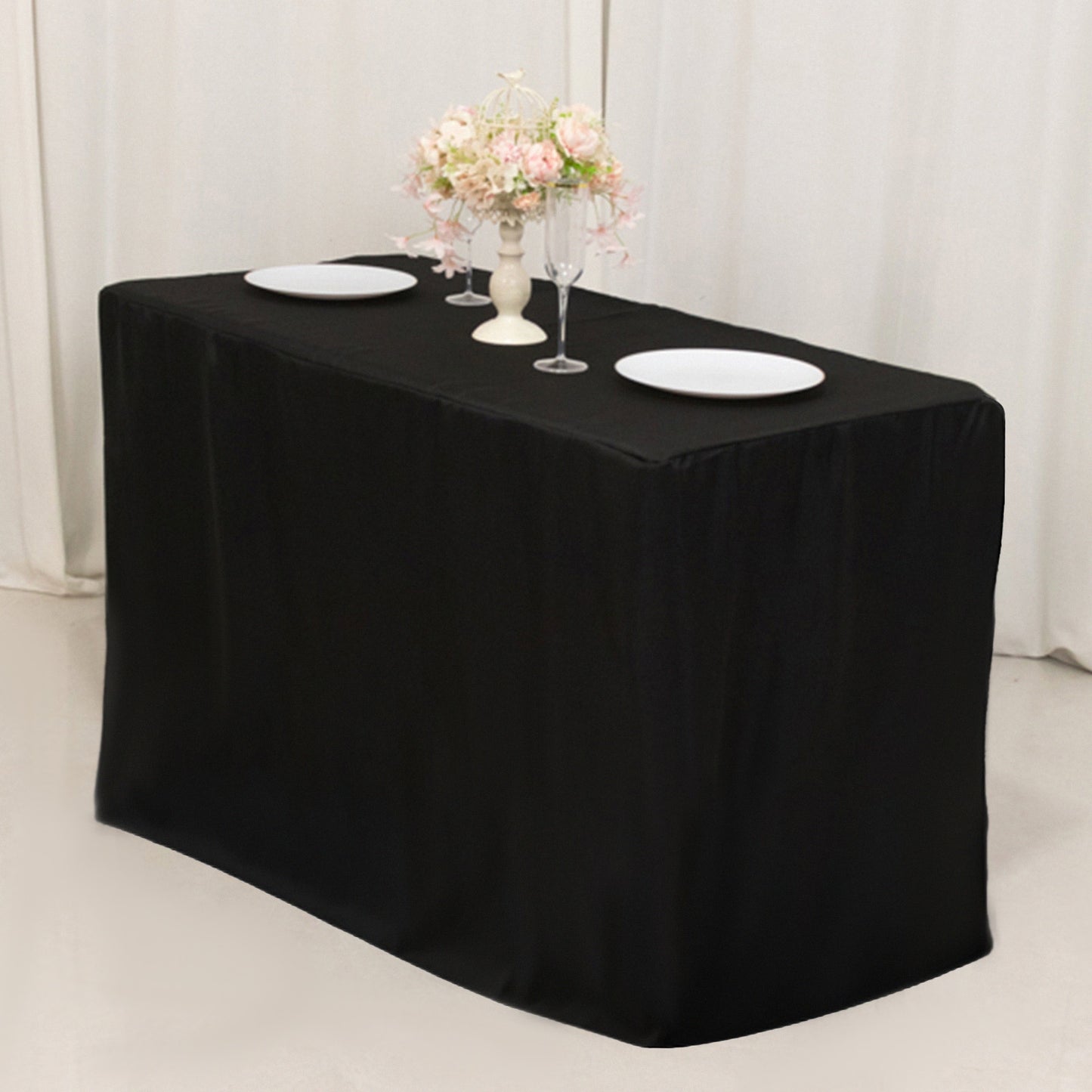 Black fitted tablecloth for 48"x24"x42" tables with elegant floral decor.