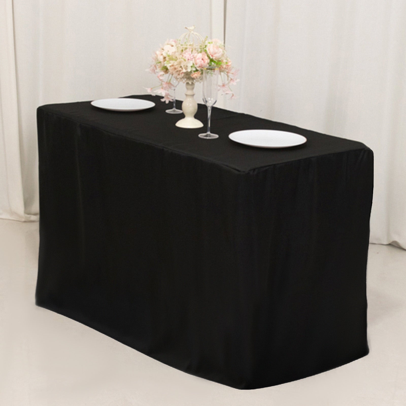 Black fitted tablecloth for 48"x24"x42" tables with elegant floral decor.