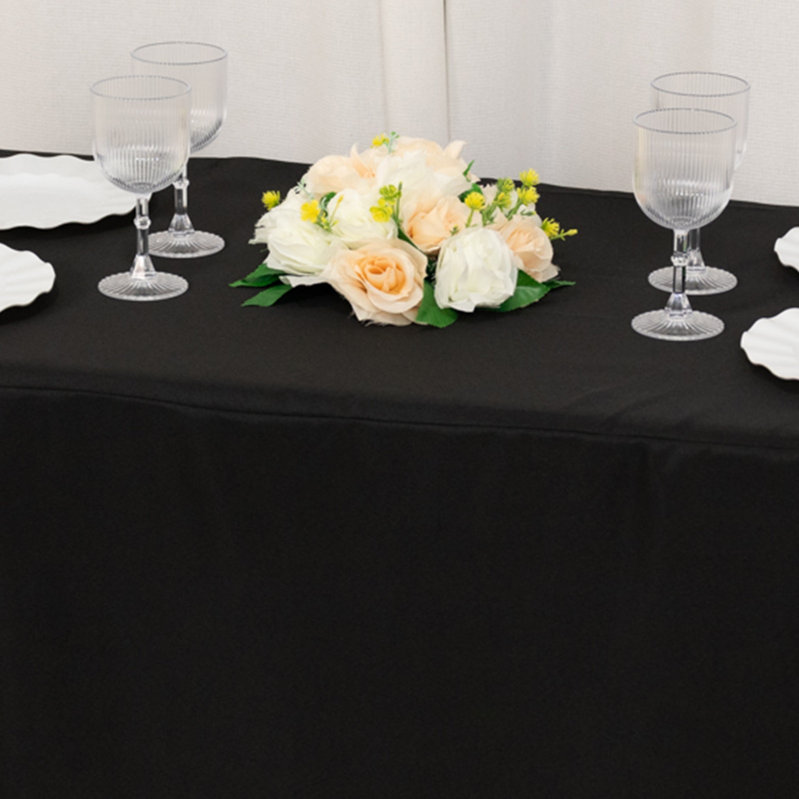 Black fitted tablecloth for 48"x24"x42" tables with floral centerpiece.