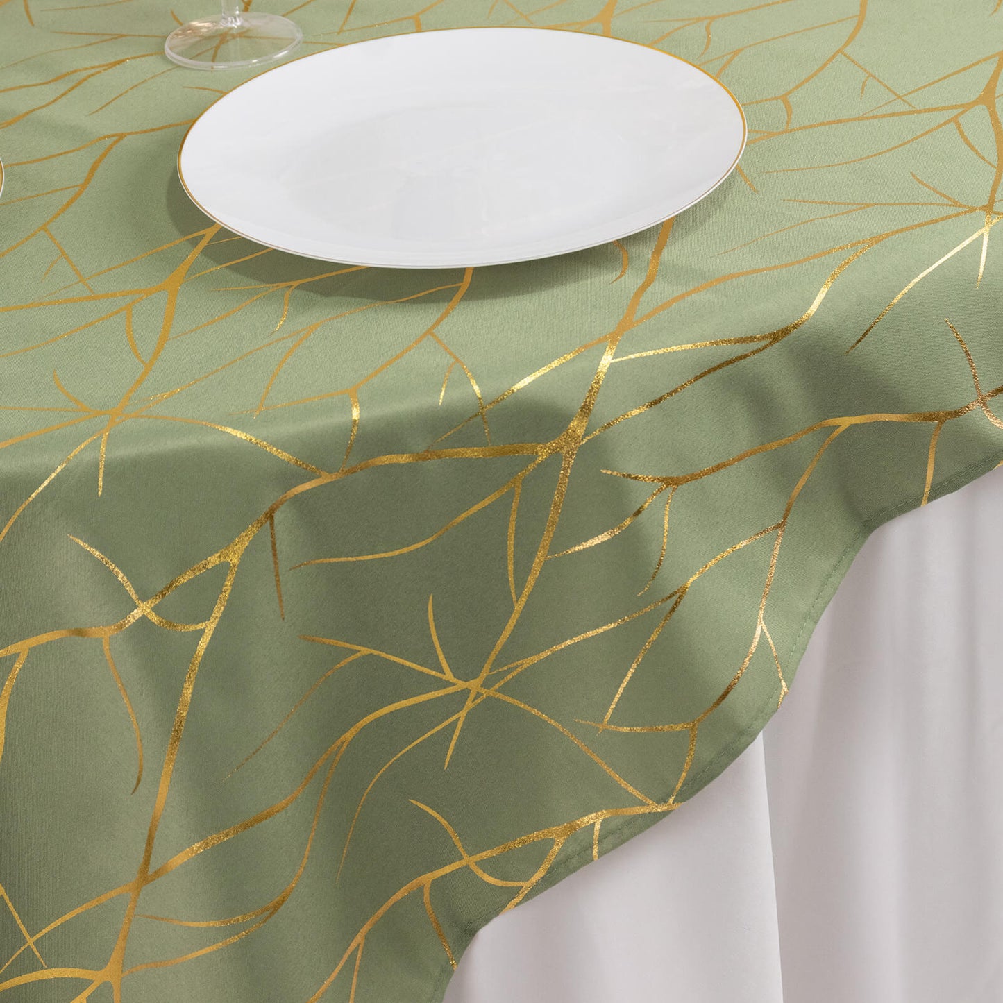 Dusty sage green table overlay with gold foil tree branch pattern.