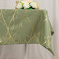 Dusty sage green tablecloth with gold foil tree branch pattern.