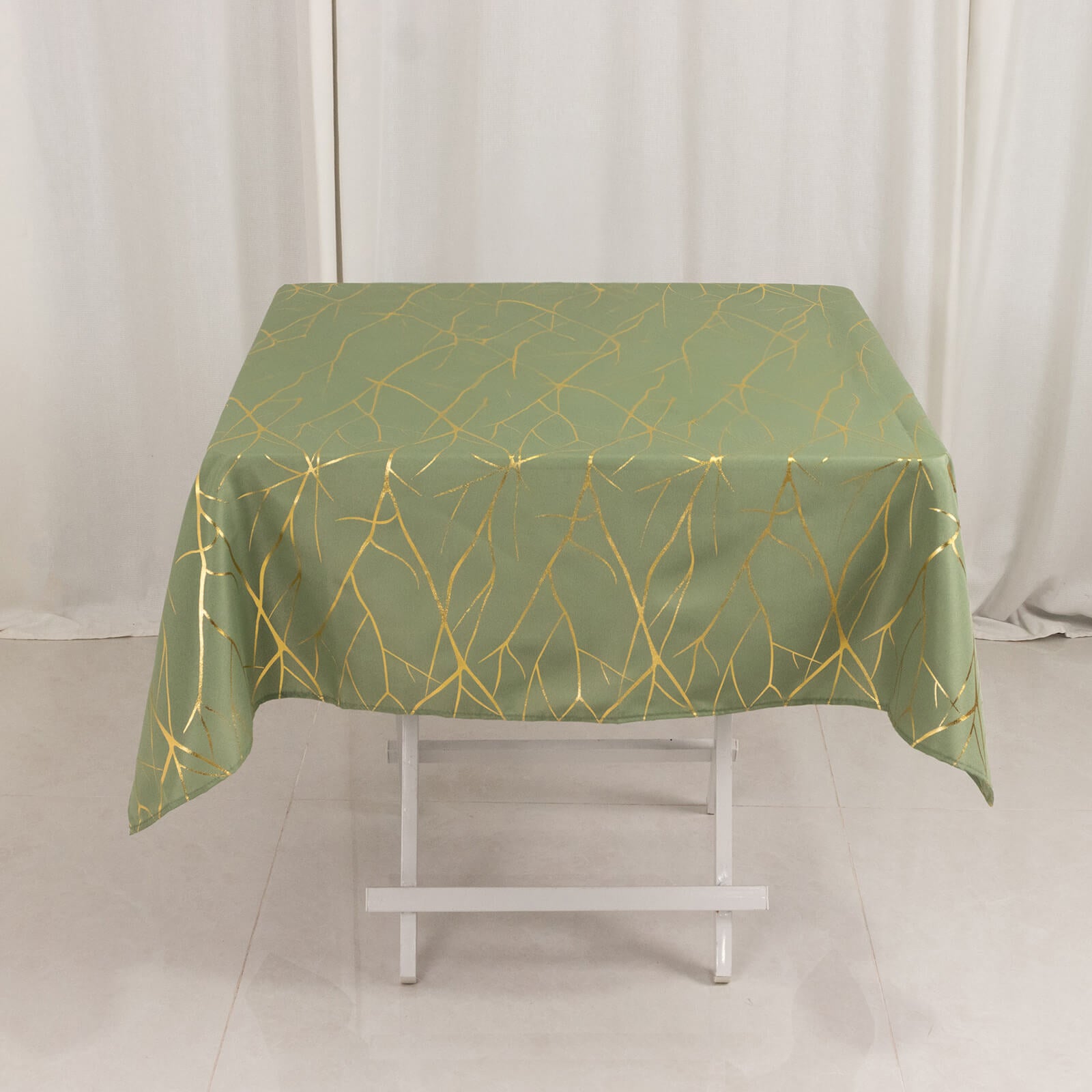 Dusty sage green tablecloth with gold foil tree branch pattern. 54"x54".
