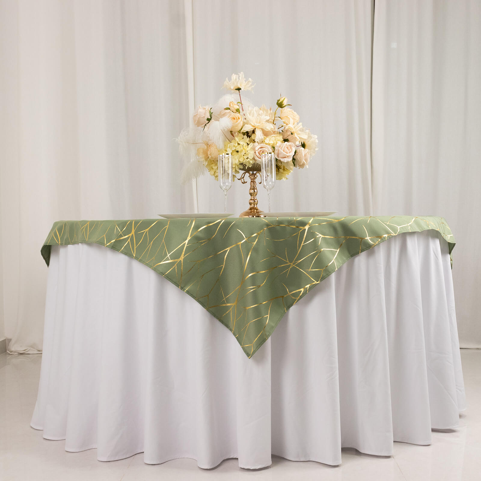 Dusty sage green table overlay with gold foil tree branch pattern.