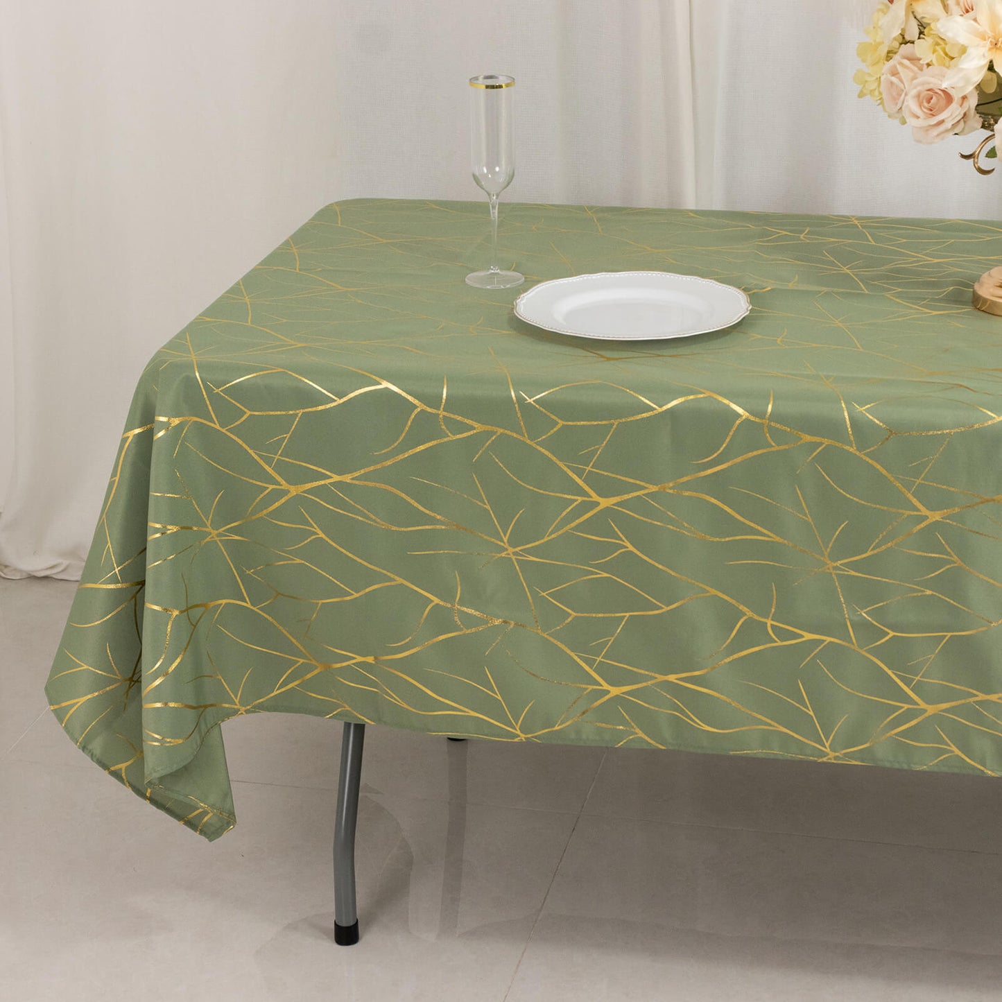 Dusty sage green tablecloth with gold foil tree branch pattern.