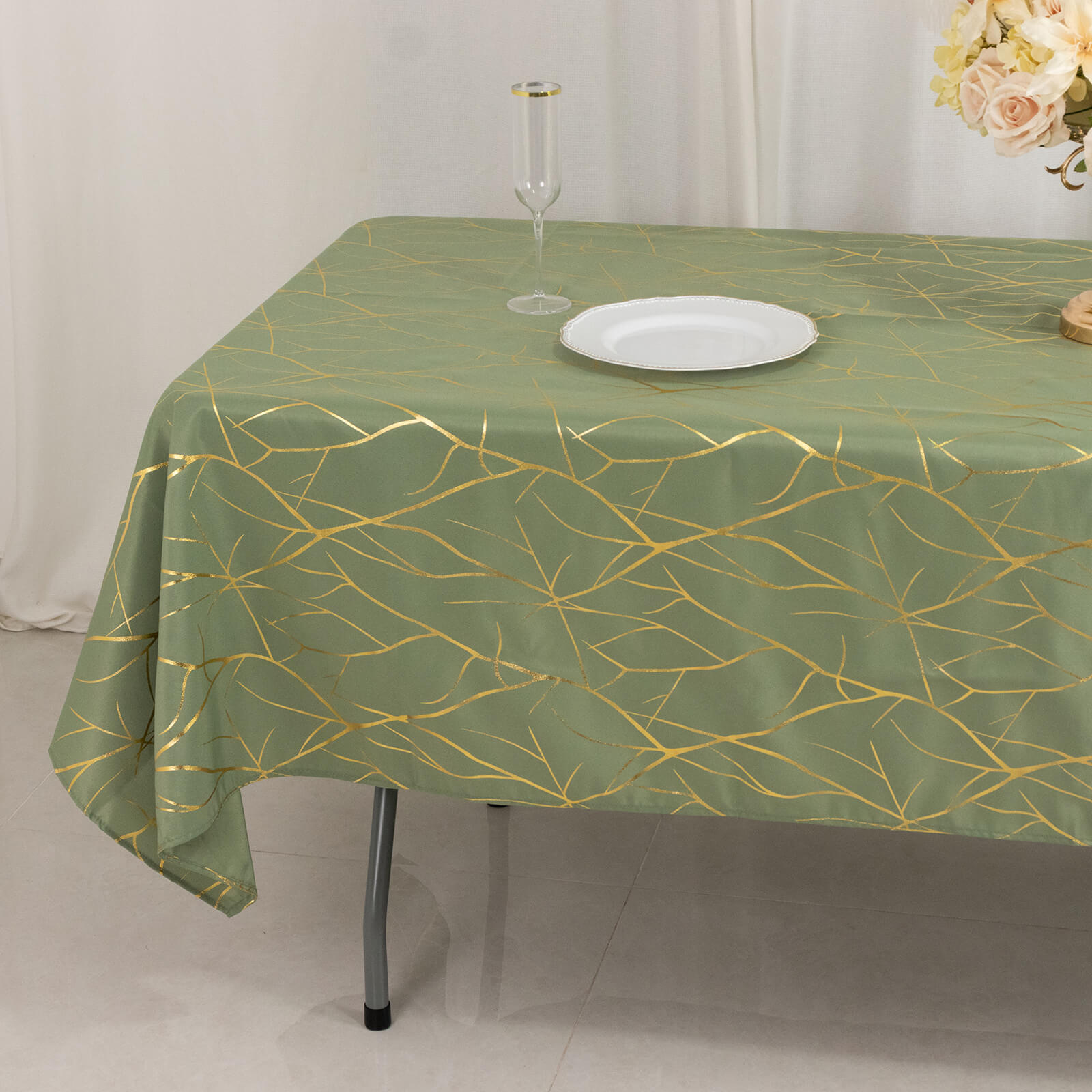 Dusty sage green tablecloth with gold foil tree branch pattern.