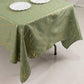 Dusty sage green tablecloth with gold foil tree branch pattern.