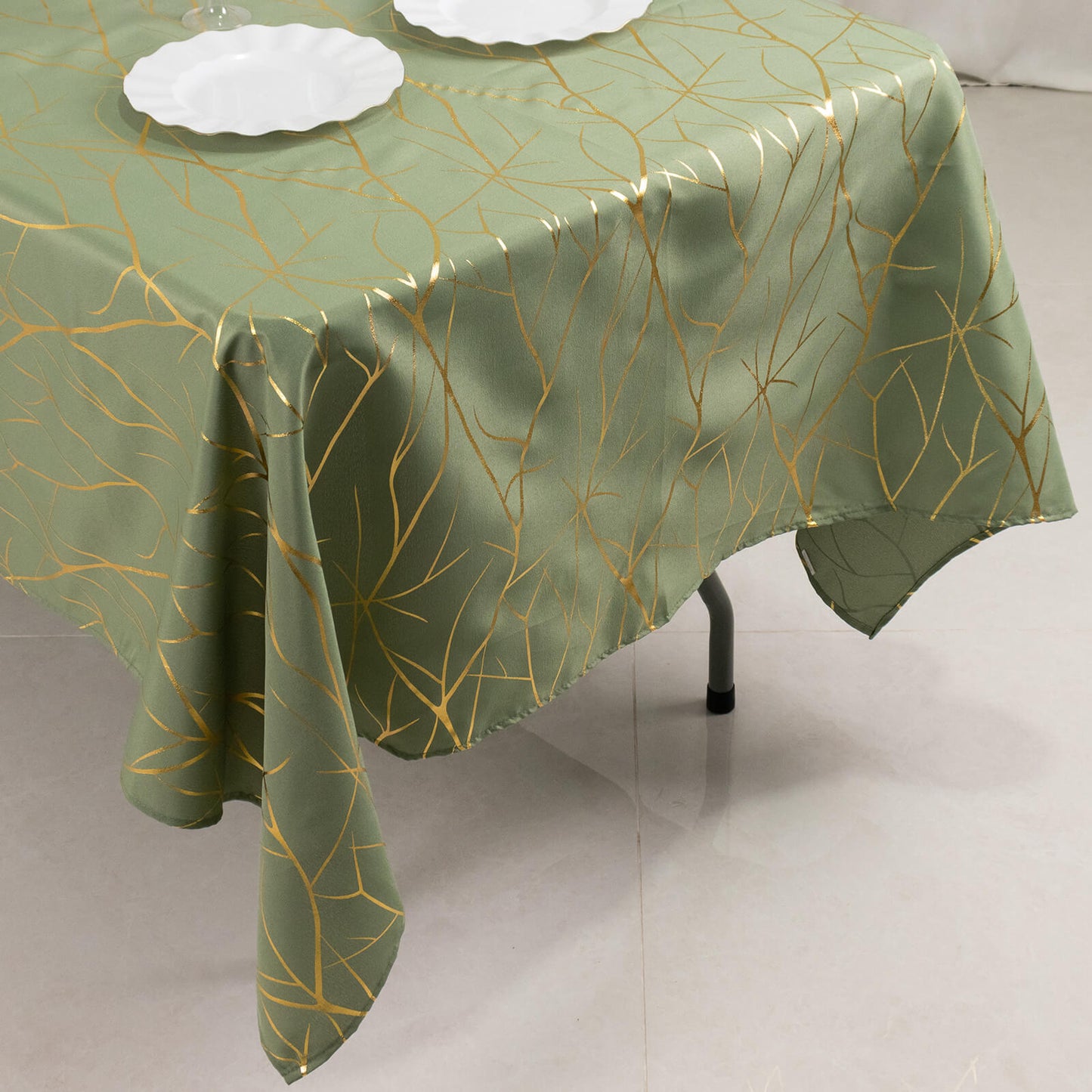 Dusty sage green tablecloth with gold foil tree branch pattern.