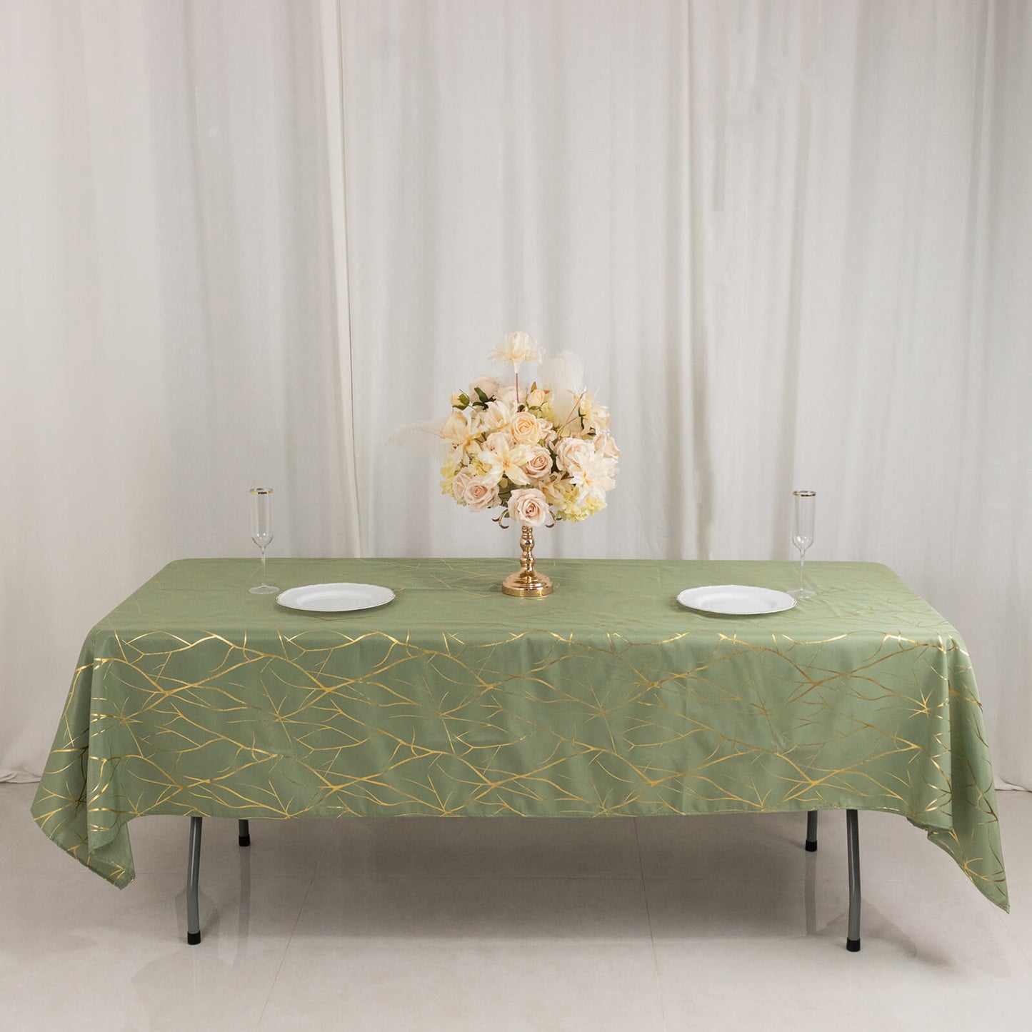 Dusty sage green tablecloth with gold foil tree branch pattern.
