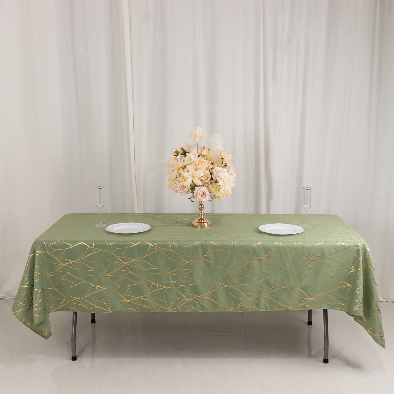 Dusty sage green tablecloth with gold foil tree branch pattern.
