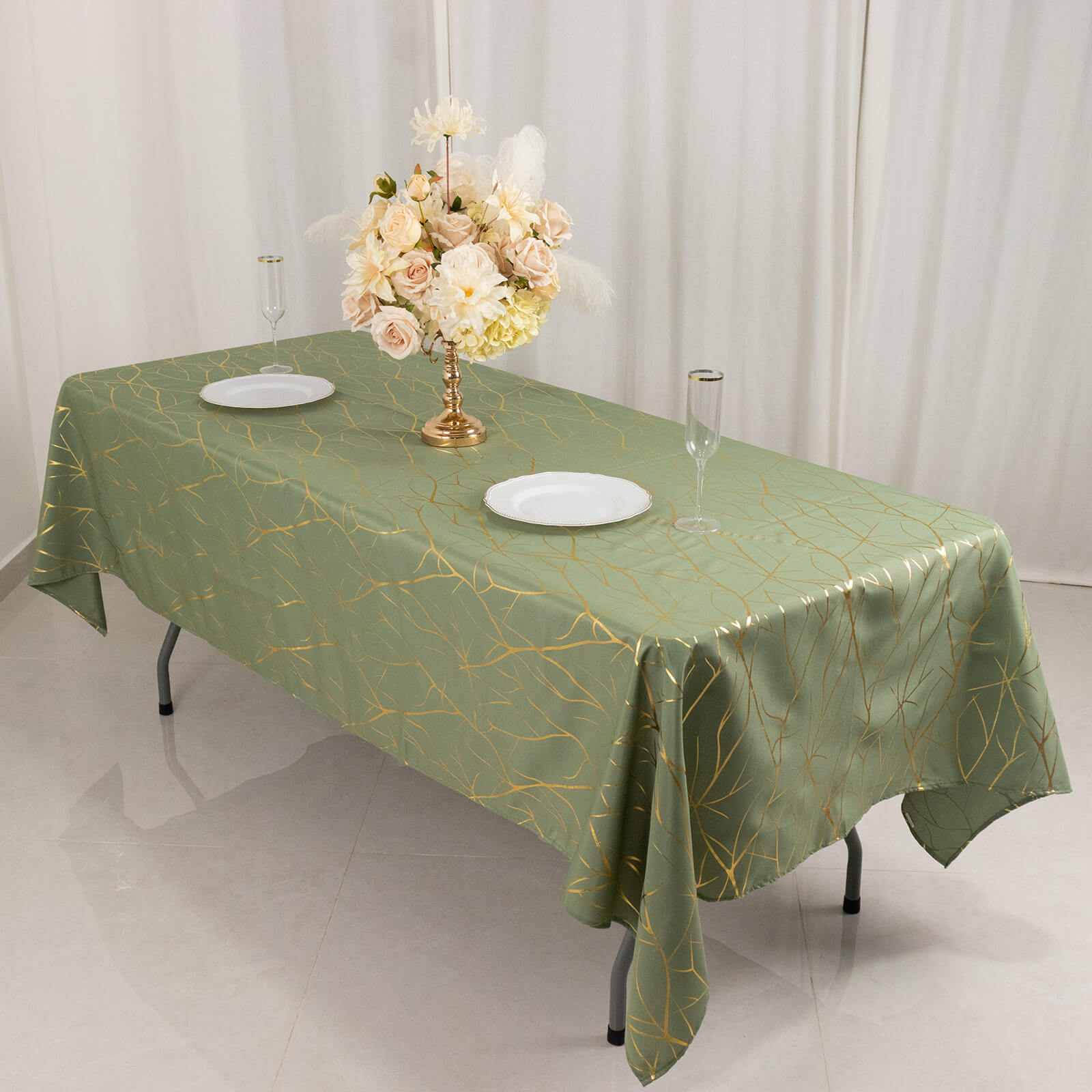 Dusty sage green tablecloth with gold foil tree branch pattern.