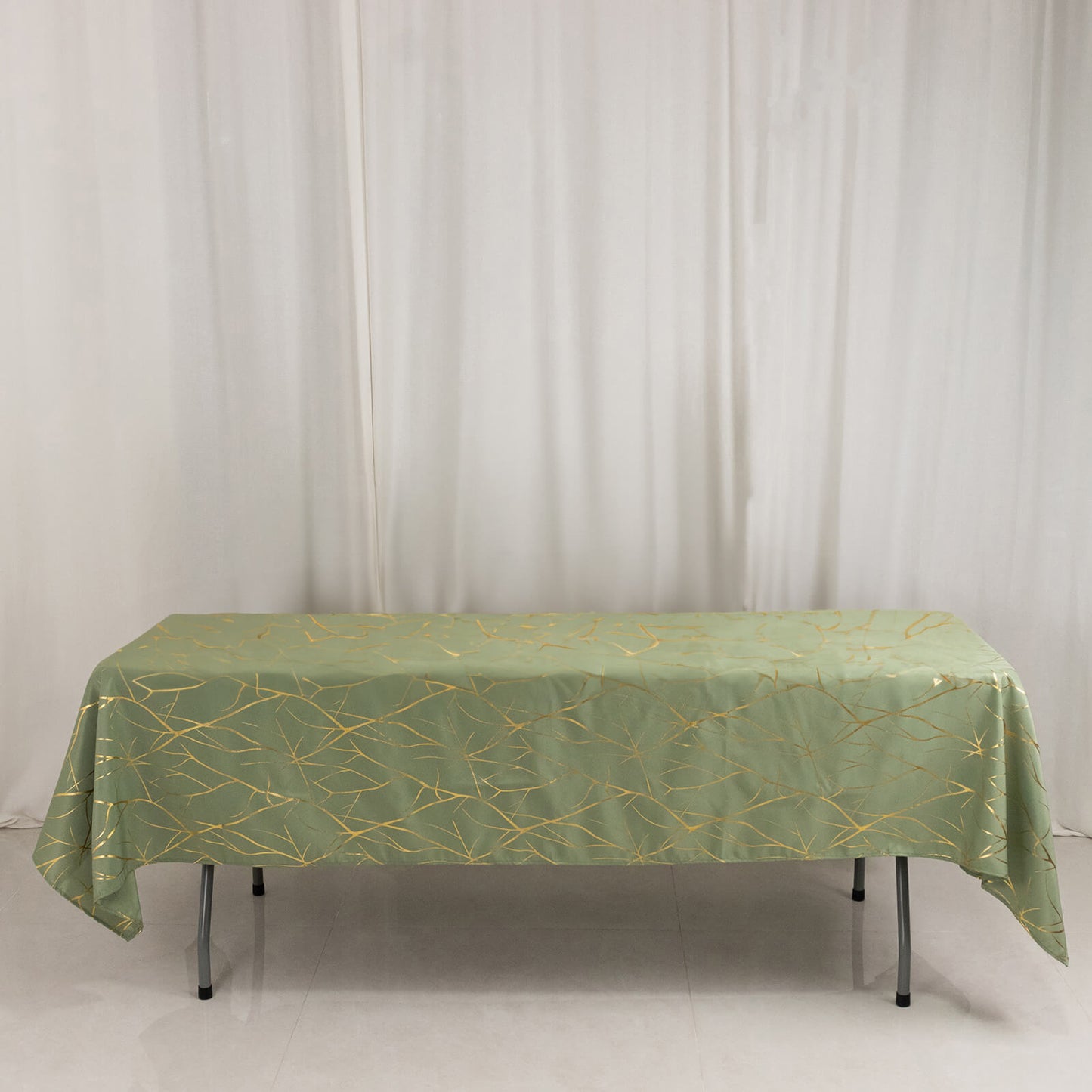 Dusty sage green tablecloth with gold foil tree branch pattern.