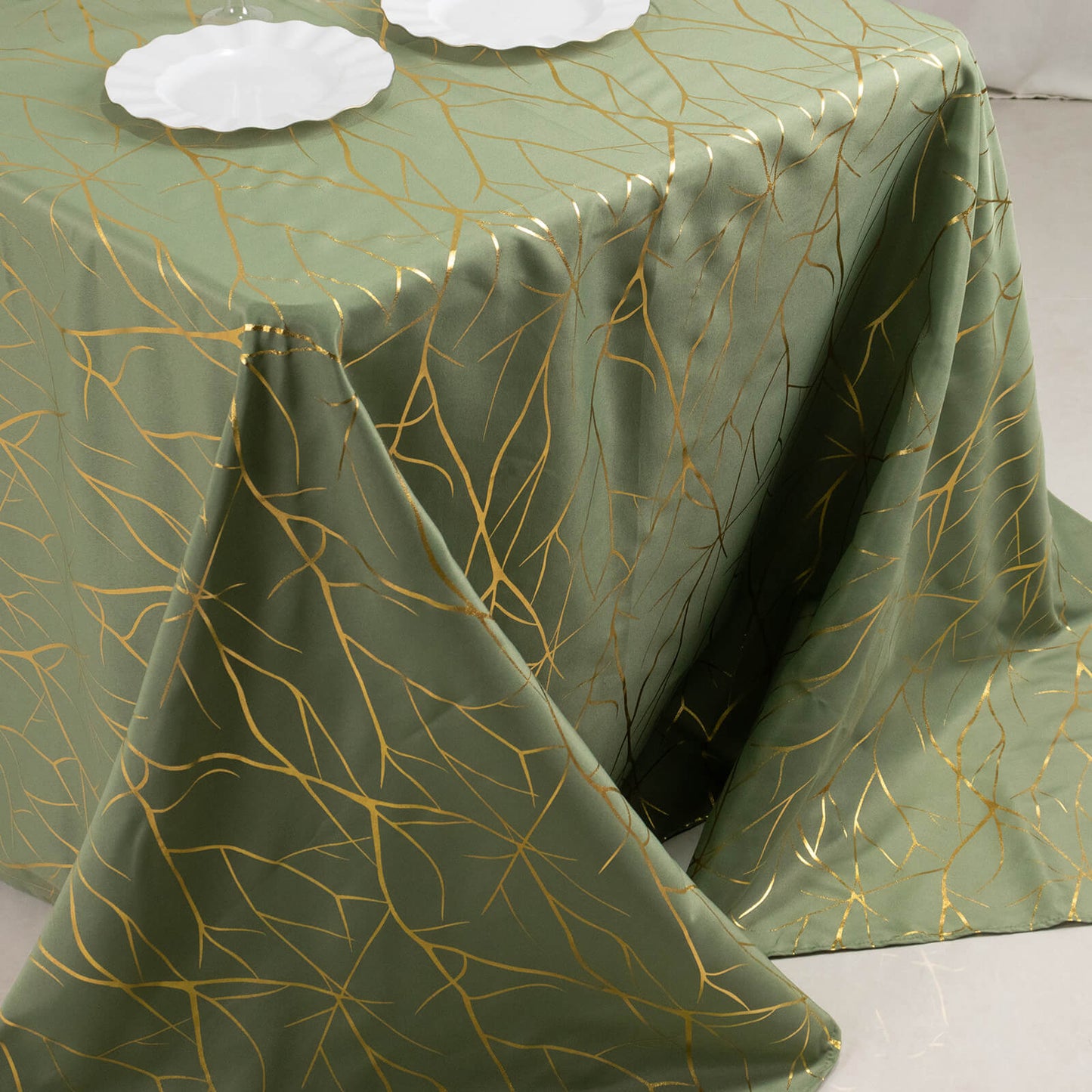 Dusty sage green tablecloth with gold foil tree branch pattern.
