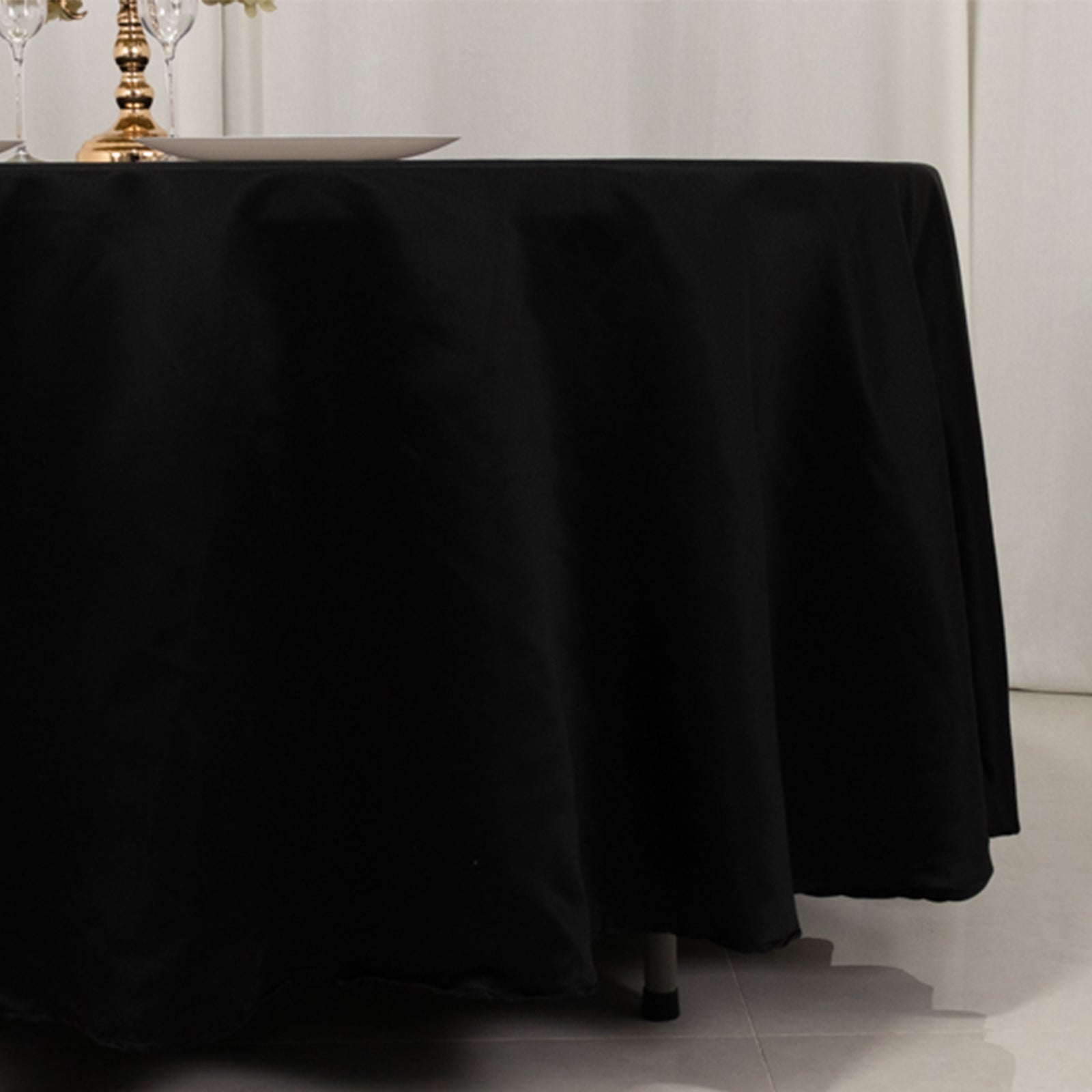 Black round satin tablecloth, 108 inches.