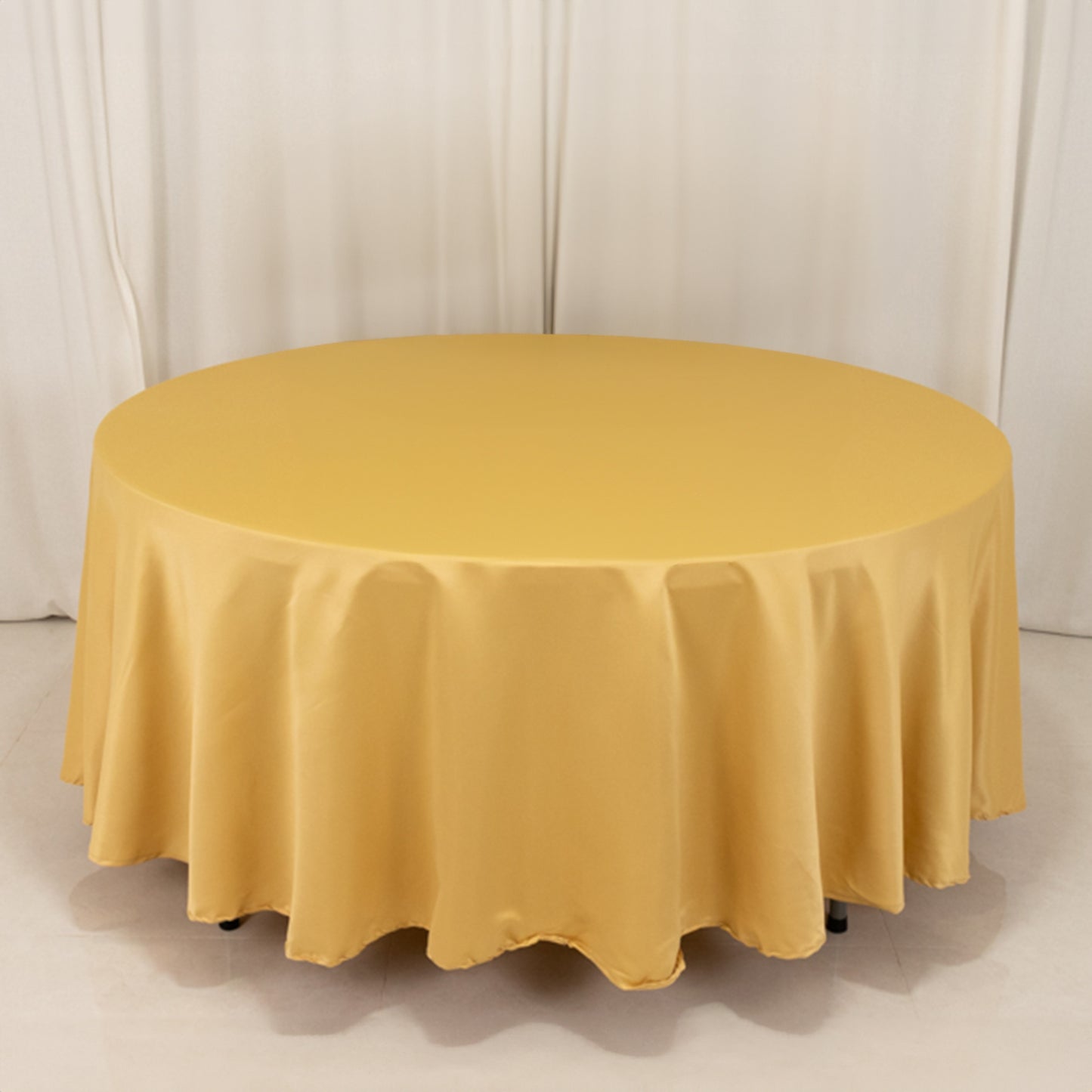 Champagne satin round tablecloth on a circular table.